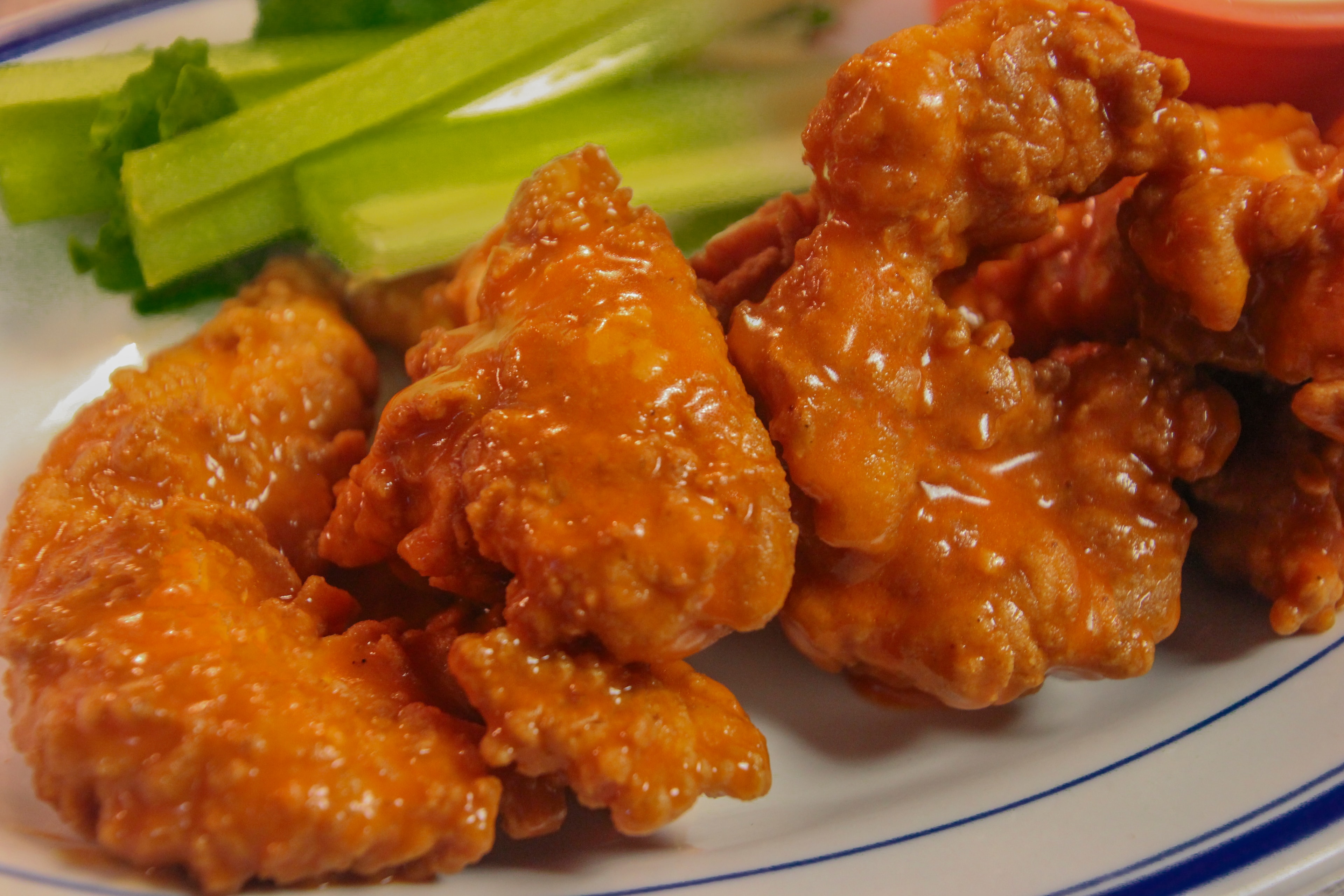 Buffalo chicken wings tossed in tangy hot sauce served with celery sticks and dipping sauce
